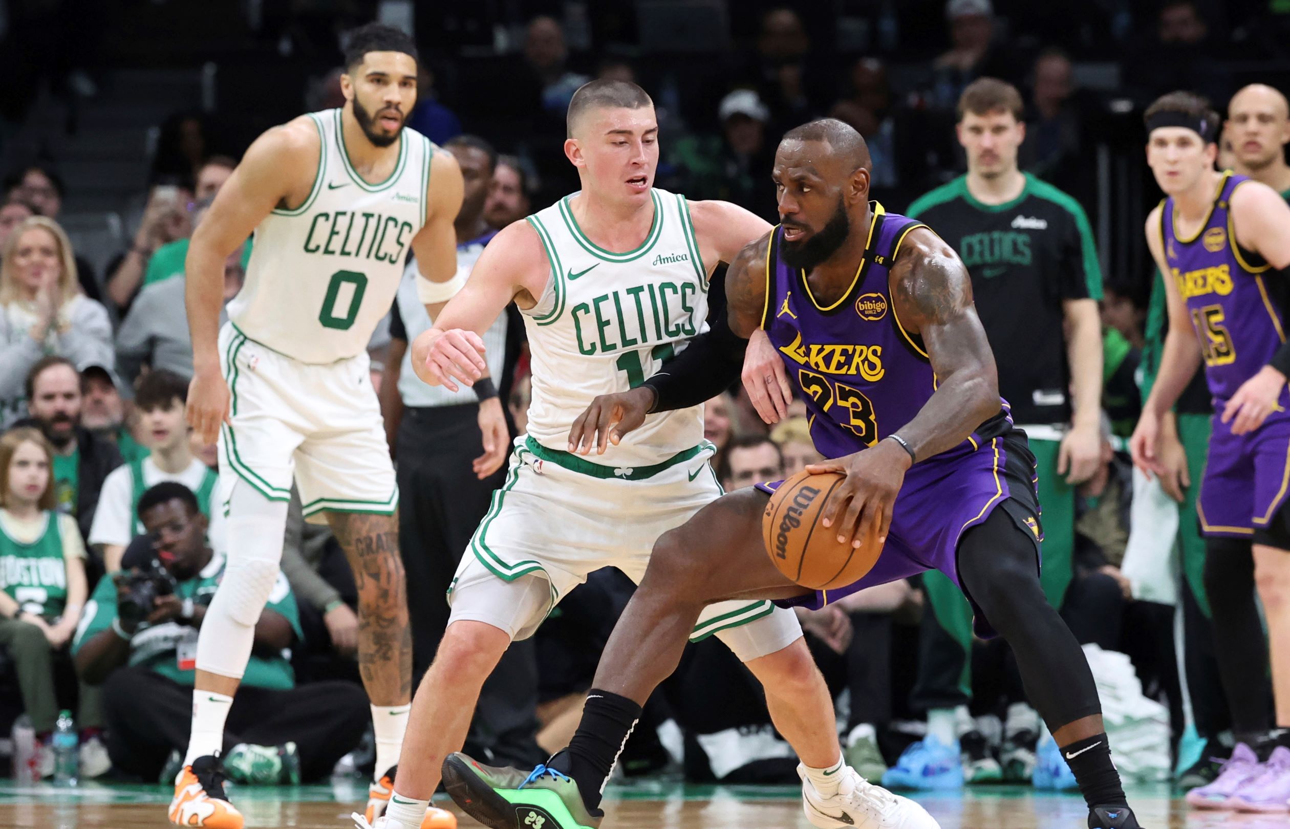Los Angeles Lakers forward LeBron James (23) defends the ball from Boston Celtics guard Payton Pritchard (11) during the second half of an NBA basketball game, Saturday, March 8, 2025, in Boston. (AP Photo/Mark Stockwell) Lakers Celtics Basketball