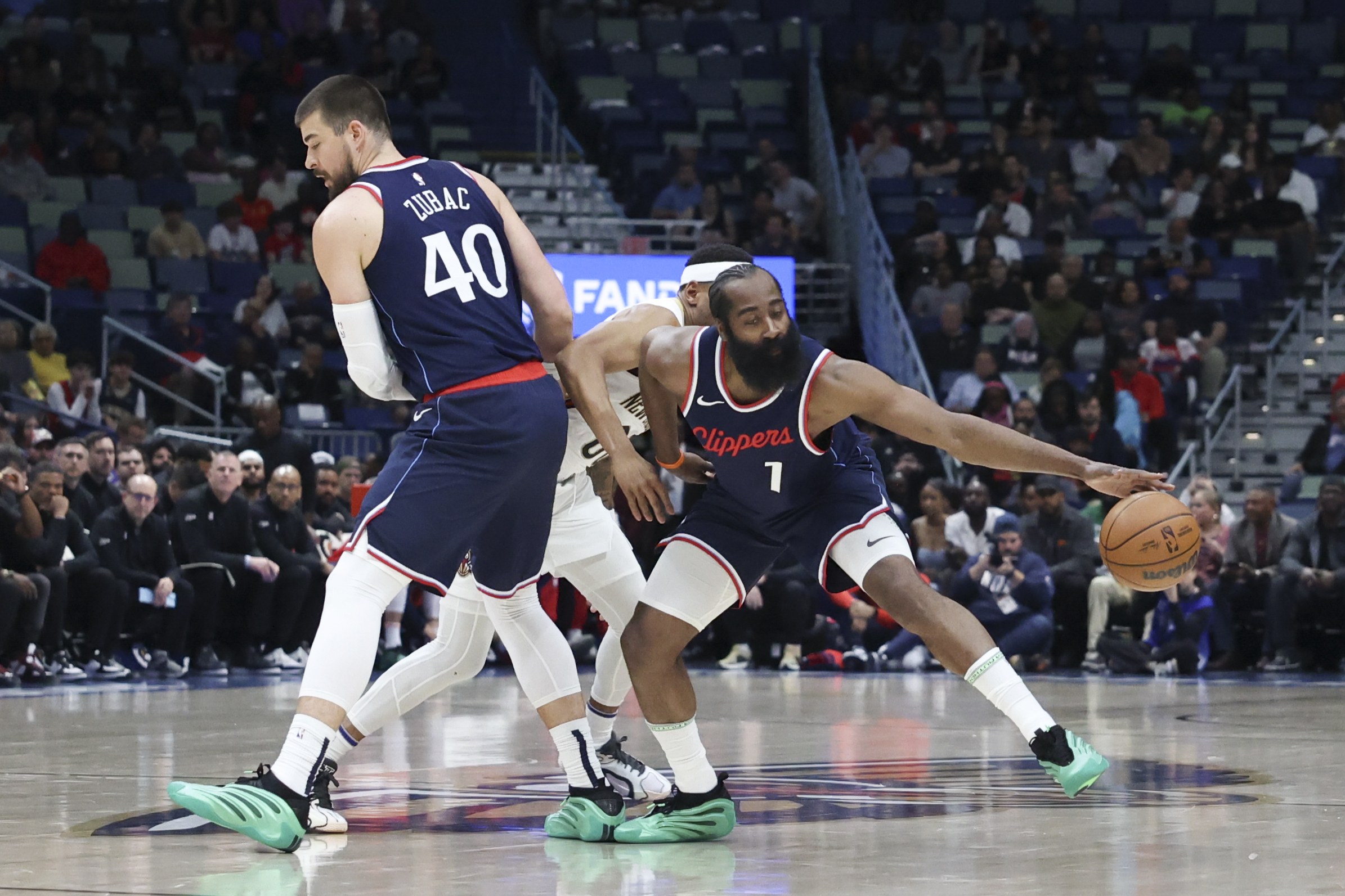 Los Angeles Clippers guard James Harden (1) tries to make a move while center Ivica Zubac (40) sets a pick on New Orleans Pelicans forward Bruce Brown (00) in the first half of an NBA basketball game in New Orleans, Tuesday, March 11, 2025. (AP Photo/Peter Forest)