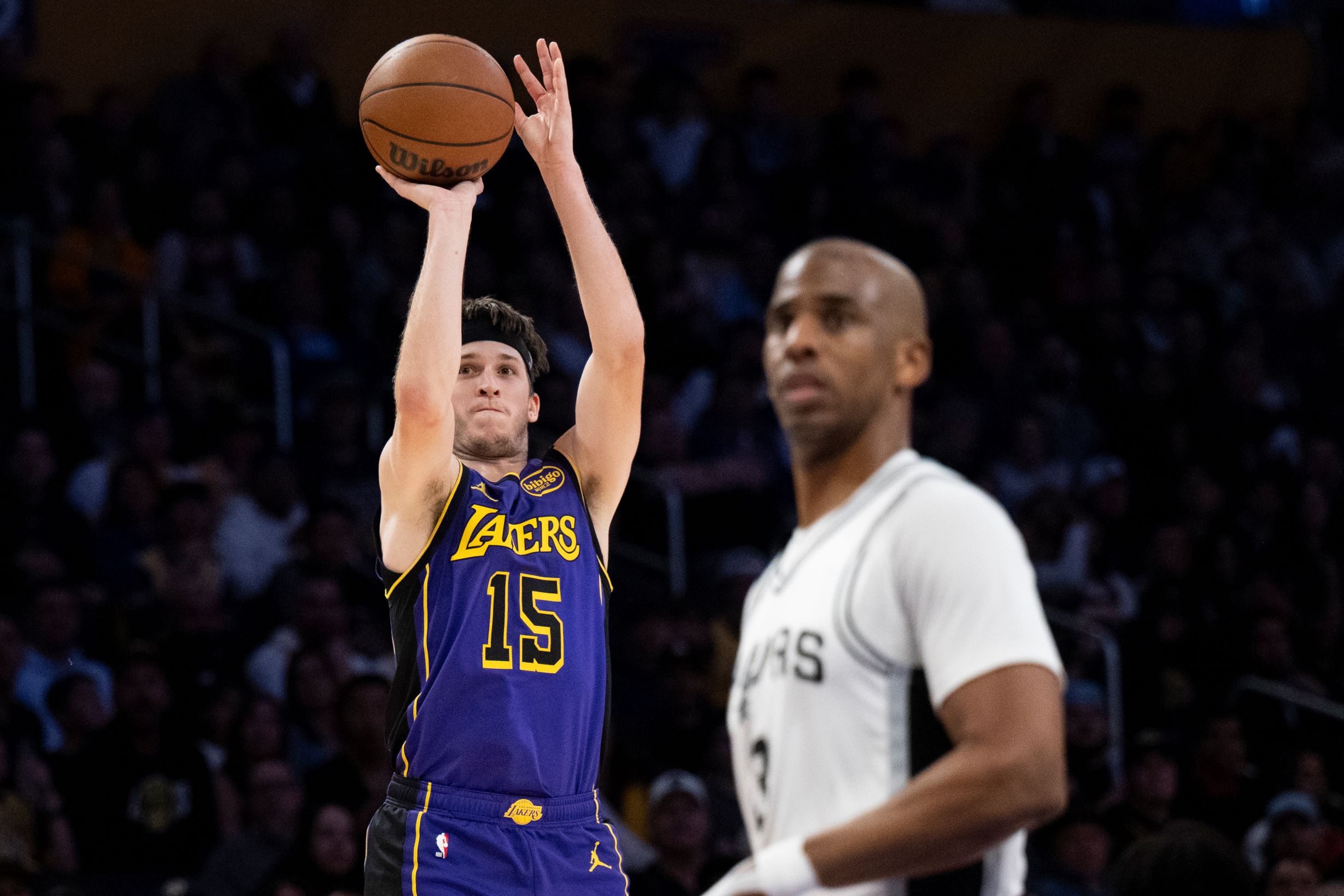 Los Angeles Lakers guard Austin Reaves (15) shoots a 3-pointer during the second half of an NBA basketball game against the San Antonio Spurs in Los Angeles, Monday, March 17, 2025. (AP Photo/Kyusung Gong) Spurs Lakers Basketball