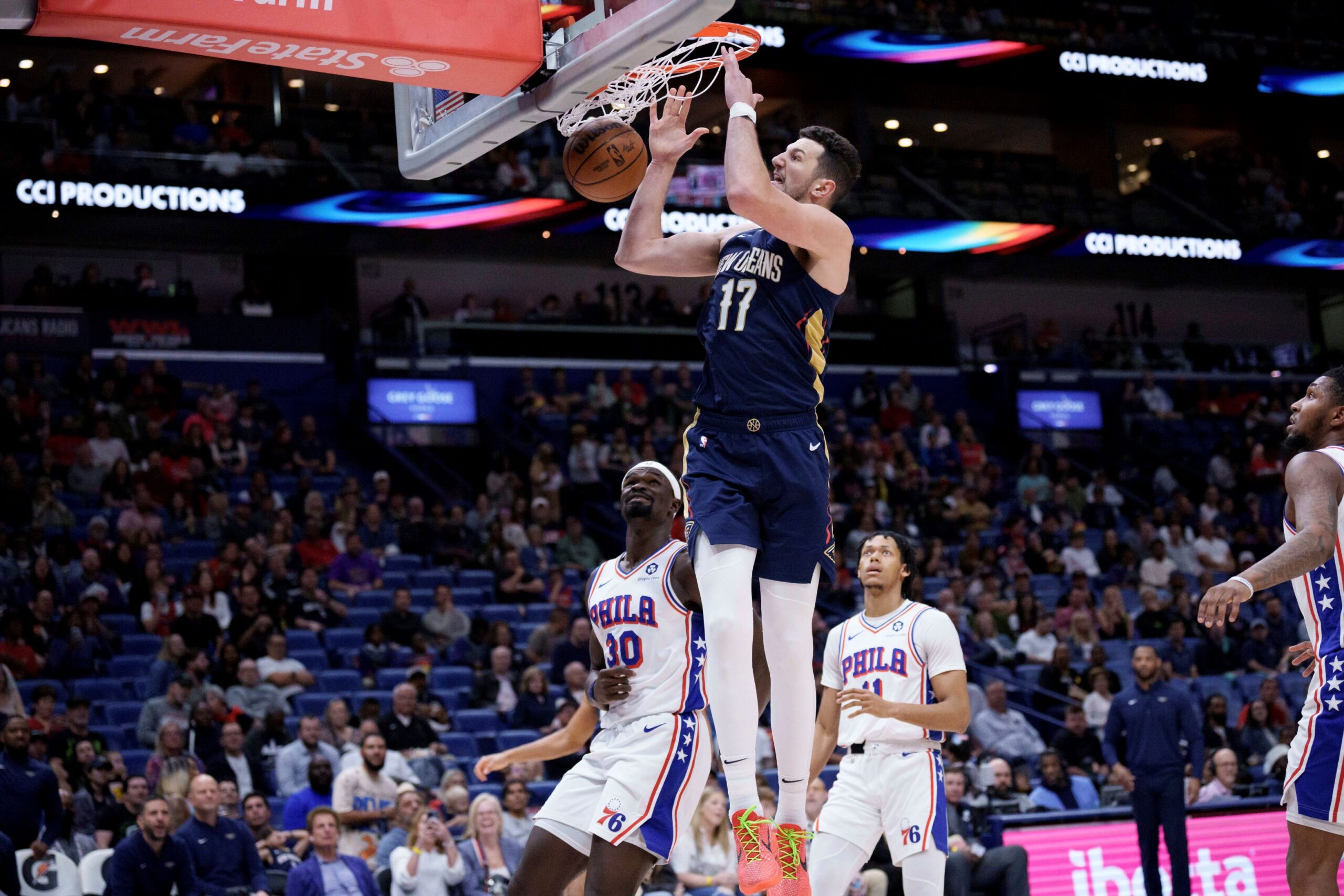 New Orleans Pelicans center Karlo Matkovic (17) dunks against Philadelphia 76ers center Adem Bona (30) during the first half of an NBA basketball game in New Orleans, Monday, March 24, 2025. (AP Photo/Matthew Hinton) 76ers Pelicans Basketball