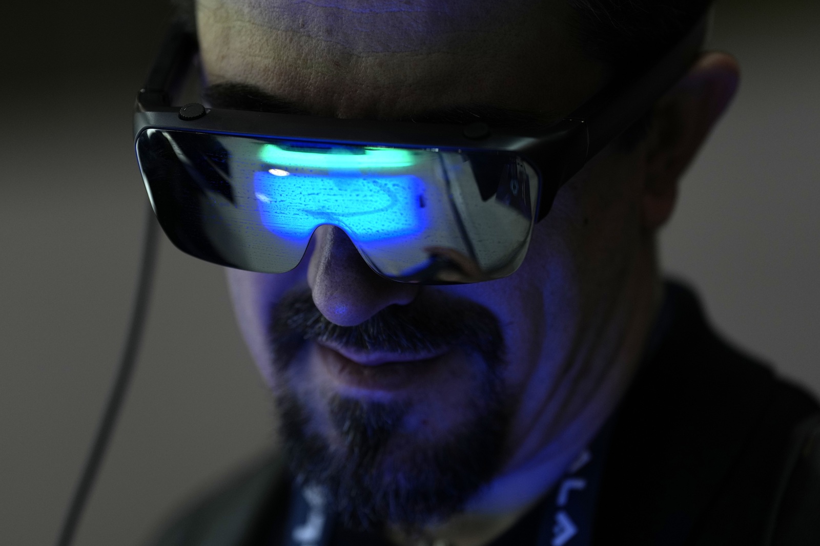 epa11942214 A visitor tries on a model of smart glasses at the Tecno AI stand on the third day of MWC 2025 in Barcelona, Spain, 05 March 2025. The MWC 2025 is expected to gather more than 100,000 visitors, turning Barcelona into the global epicenter of technology.  EPA/ALEJANDRO GARCIA