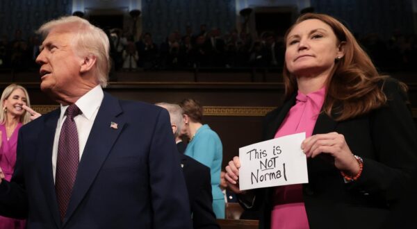 WASHINGTON, DC - MARCH 04: U.S. President Donald Trump arrives for his speech to a joint session of Congress as Rep. Melanie Stansbury (D-NM) holds a sign reading "This is not normal" at the U.S. Capitol on March 04, 2025 in Washington, DC. President Trump was expected to address Congress on his early achievements of his presidency and his upcoming legislative agenda. 
Credit: Win McNamee / Pool via CNP/AdMedia Photo: CNP/AdMedia/NEWSCOM