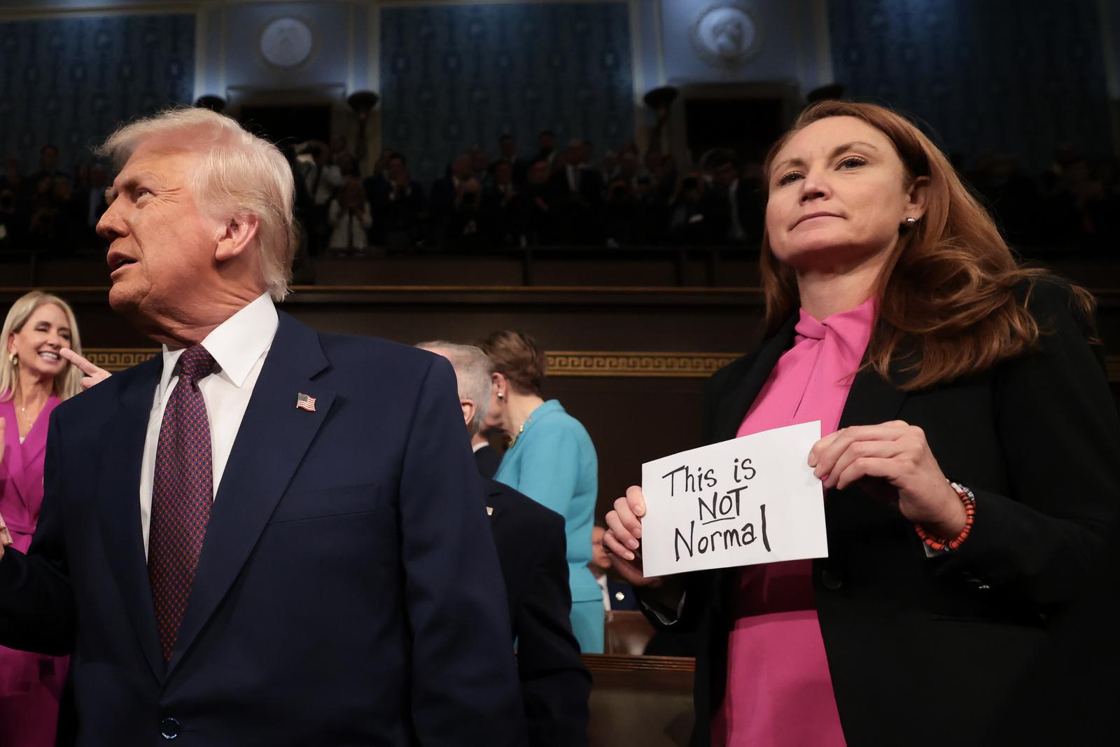 WASHINGTON, DC - MARCH 04: U.S. President Donald Trump arrives for his speech to a joint session of Congress as Rep. Melanie Stansbury (D-NM) holds a sign reading "This is not normal" at the U.S. Capitol on March 04, 2025 in Washington, DC. President Trump was expected to address Congress on his early achievements of his presidency and his upcoming legislative agenda. 
Credit: Win McNamee / Pool via CNP/AdMedia Photo: CNP/AdMedia/NEWSCOM