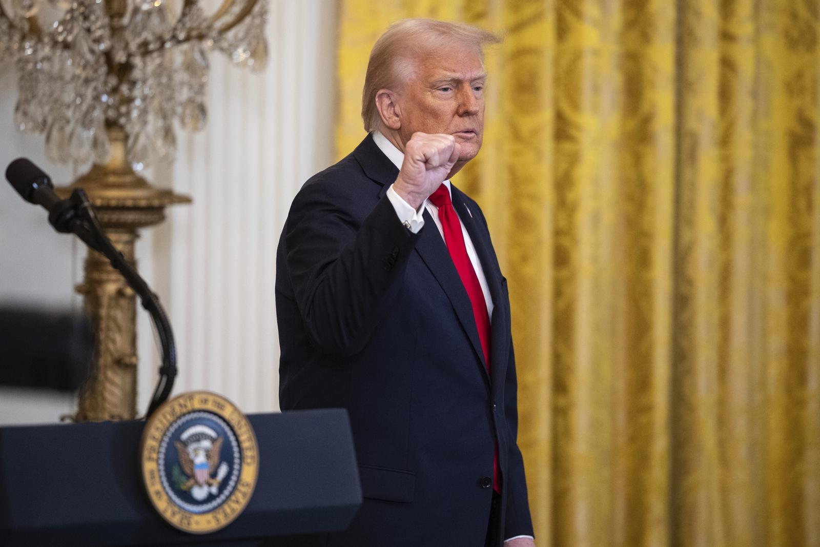 United States President Donald J Trump raises his fist at the end of a Women's History Month event in the East Room of the White House in Washington, DC, USA, March 26, 2025. Credit: Francis Chung / Pool via CNP