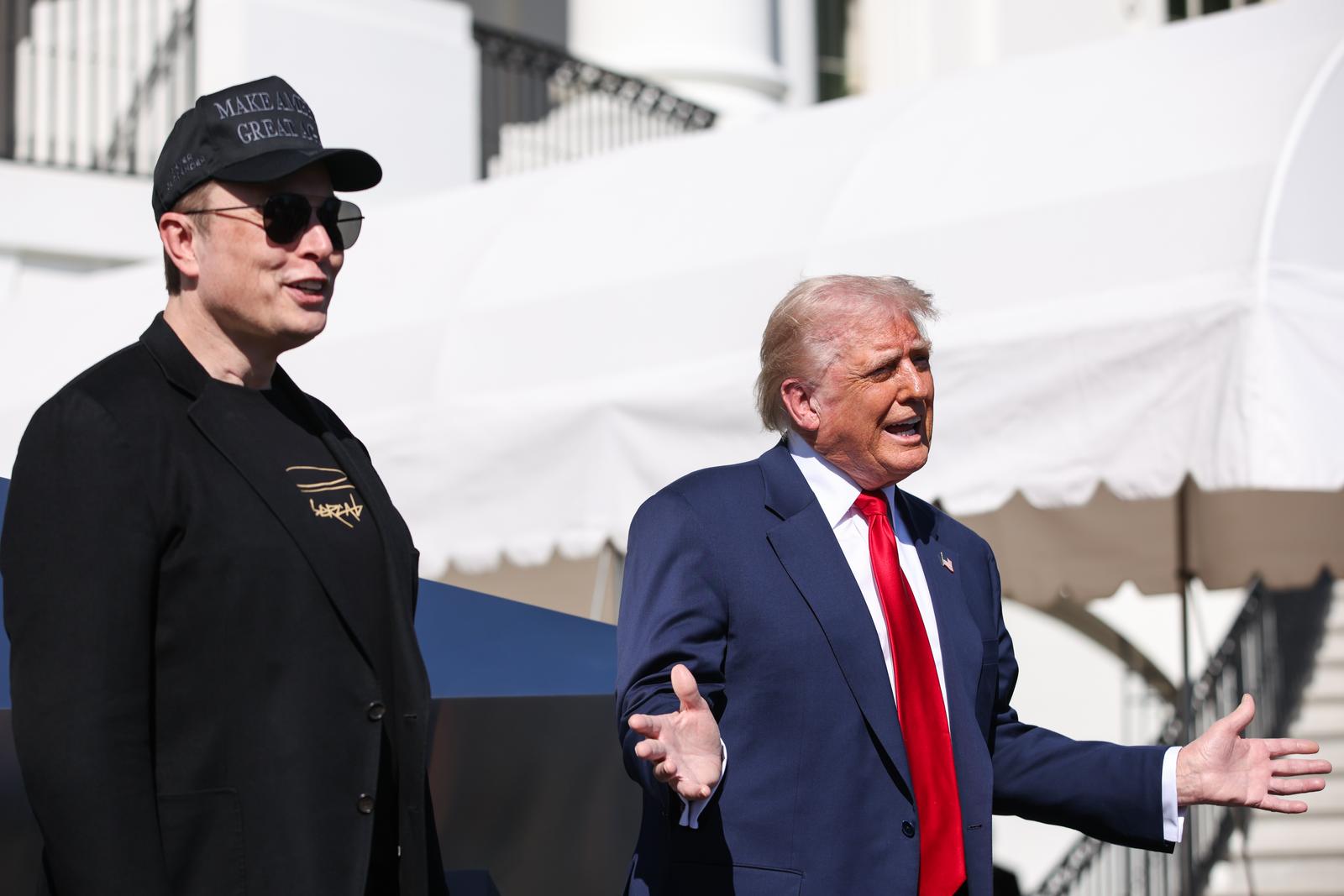 Elon Musk, Tesla CEO and Senior Advisor to the President of the United States, looks on as US President Donald Trump speaks in front of Tesla vehicles at the White House in Washington, D.C. on March 11, 2025. President Trump has said he will buy a Tesla to support Tesla and Elon Musk after recent attacks on Tesla charging stations and calls for boycotts of Tesla products.   Credit: Samuel Corum / Pool via CNP Photo via Newscom Photo: Samuel Corum - Pool via CNP/NEWSCOM