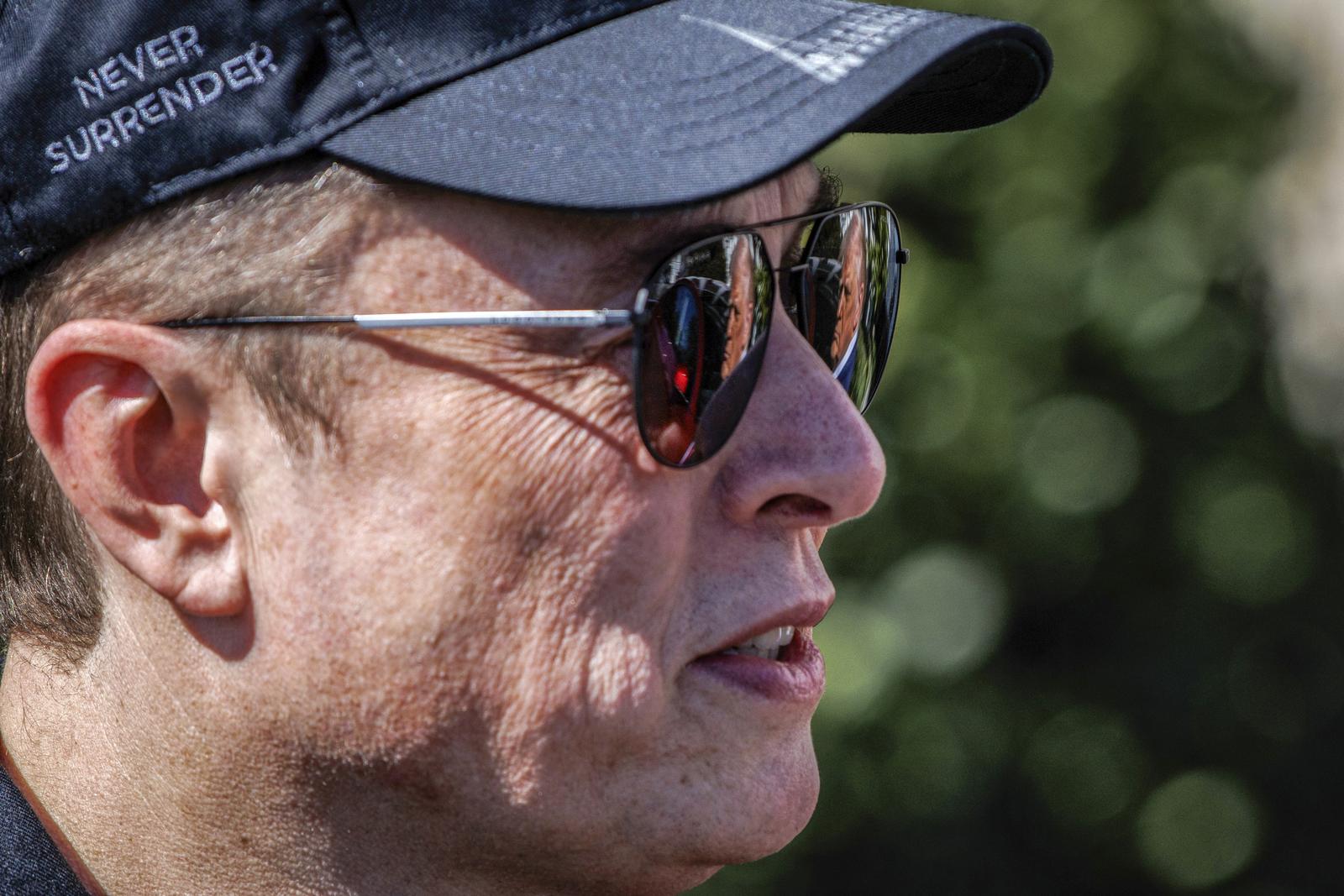 United States President Donald Trump is reflected in the sunglasses of Elon Musk, Tesla CEO and Senior Advisor to the President of the United States, as he speaks in front of Tesla vehicles at the White House in Washington, D.C. on March 11, 2025. President Trump has said he will buy a Tesla to support Tesla and Elon Musk after recent attacks on Tesla charging stations and calls for boycotts of Tesla products. Credit: Samuel Corum / Pool via CNP