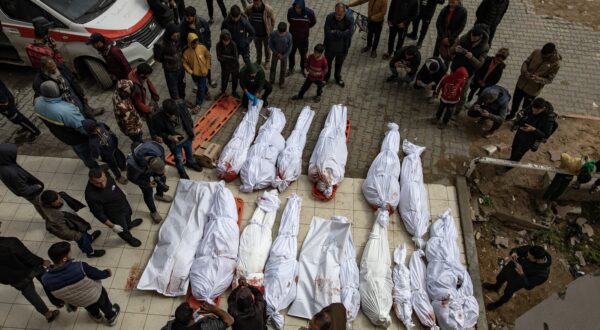 epa11975516 Palestinians stand next to the bodies of relatives killed in overnight Israeli airstrikes in the northern Gaza Strip, outside the Indonesian Hospital in Beit Lahia, 20 March 2025. On 18 March Israeli forces resumed airstrikes on Gaza ending a ceasefire held in place since 19 January and killing over 400 people on the first day, the Health Ministry confirmed.  EPA/HAITHAM IMAD