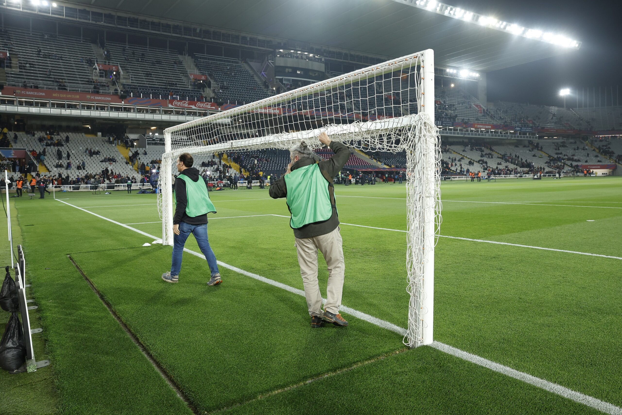 epa11950150 Workers collect the goal nets due to the suspension of the Spanish LaLiga soccer match between FC Barcelona and CA Osasuna, at the Estadi Olimpic Lluis Companys, in Barcelona, Spain, 08 March 2025. The match suspended shortly before kick off due to the death of Barcelona first team doctor Carles Minarro Garcia.  EPA/Toni Albir