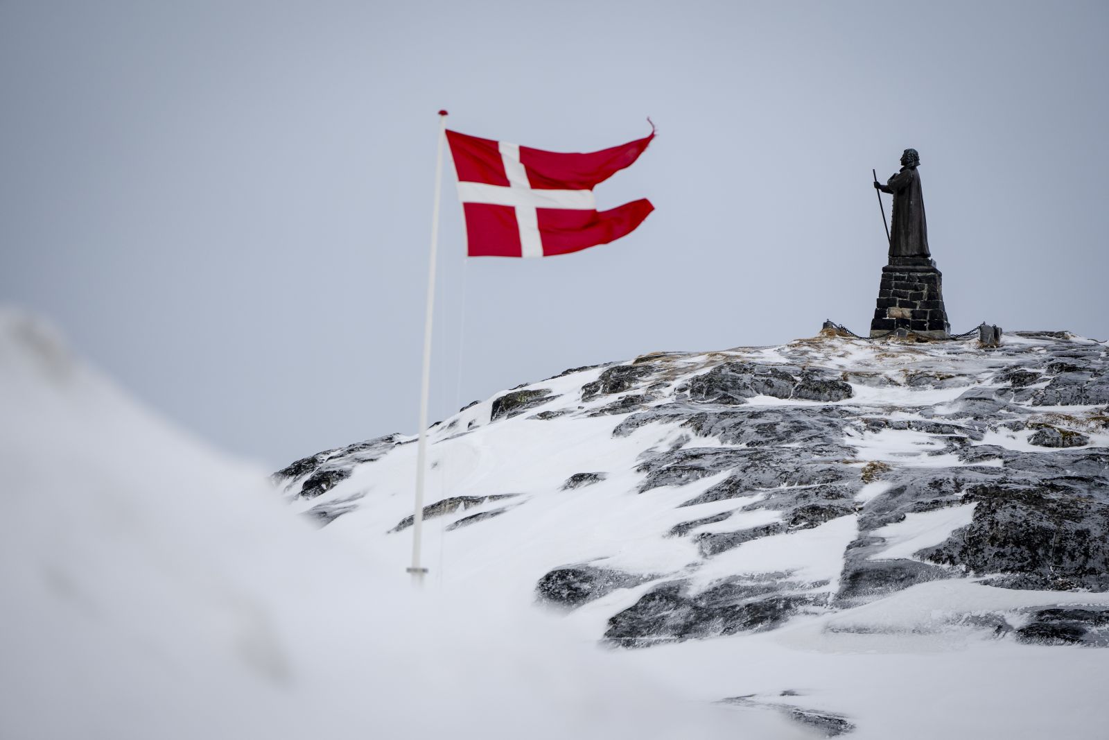 epa11953191 A view of the Dannebrog and Hans Egede Statue in Nuuk, Greenland, 09 March 2025 (issued 10 March 2025). Greenlanders are holding elections for Greenland's parliament, Inatsisartut, on 11 March 2025.  EPA/Mads Claus Rasmussen  DENMARK OUT