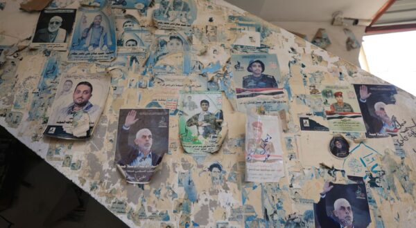 epa11957346 Posters depict late Hamas leader Yahya Sinwar and slain Houthi fighters, on a wall at a mosque, in Sana'a, Yemen, 11 March 2025.  Yemen’s Houthis vowed to resume attacks on Israeli vessels in the seas around Yemen, including the Red Sea and Bab al-Mandab strait, following the expiration of the deadline the group's leader, Abdul-Malik Al-Houthi, set four days ago for lifting the Israeli blockade of Gaza aid, Houthi military spokesperson Yahya Sarea said in a statement.  EPA/YAHYA ARHAB