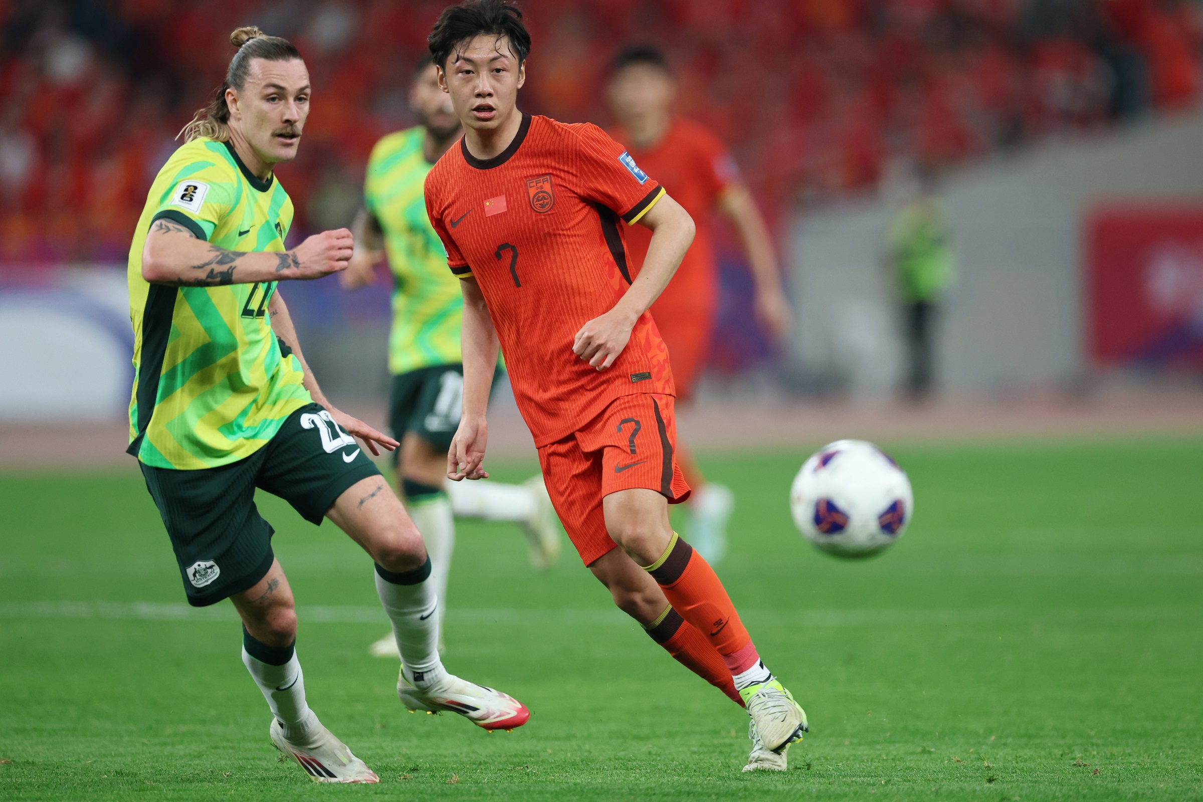 epa11987148 Xu Haoyang (R) of China in action against Jackson Irvine of Australia during the FIFA World Cup 2026 qualification match between China and Australia in Hangzhou, China, 25 March 2025.  EPA/ALEX PLAVEVSKI