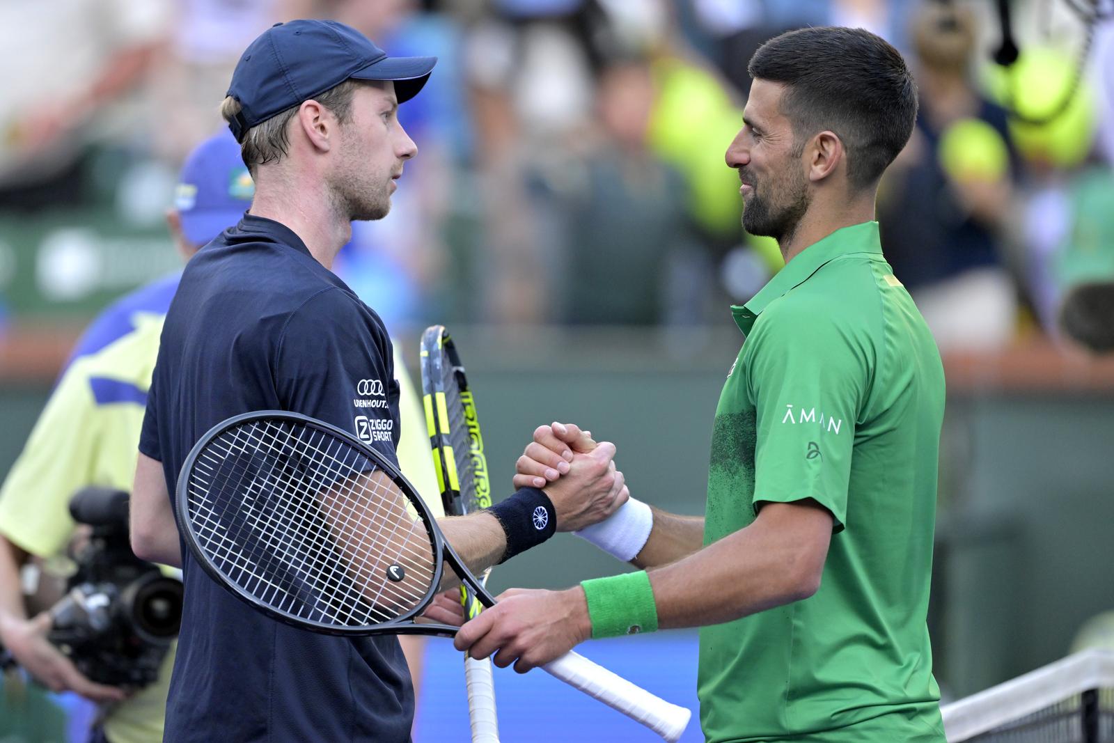 Mar 8, 2025; Indian Wells, CA, USA;  Botic Van De Zandschulp (NED) shakes hands with Novak Djokovic (SRB) after winning his second round of the BNP Paribas Open at the Indian Well Tennis Garden. Mandatory Credit: Jayne Kamin-Oncea-Imagn Images/Sipa USA Photo: Imagn Images/SIPA USA
