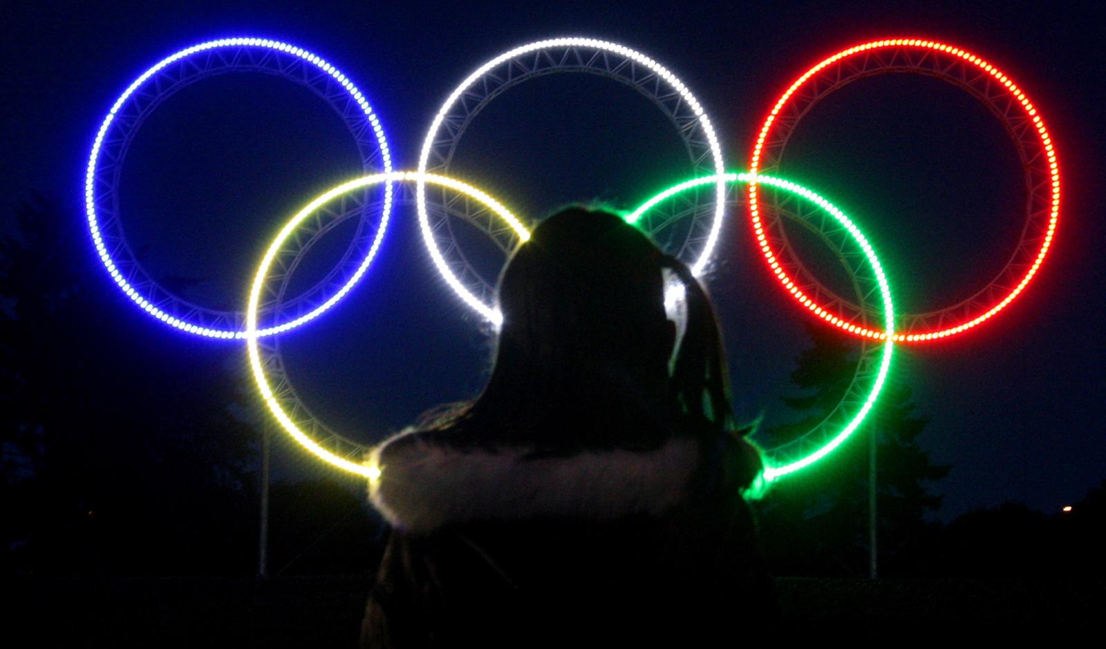 Vancouver 2010 Olympics A young girl looks at large Olympic rings that were lit up on the road leading from Vancouver International Airport in Richmond, British Columbia, to Vancouver on Thursday, March 5, 2009. Vancouver, Richmond and Whistler will host the 2010 Winter Olympic Games. (AP Photo/The Canadian Press, Darryl Dyck)
