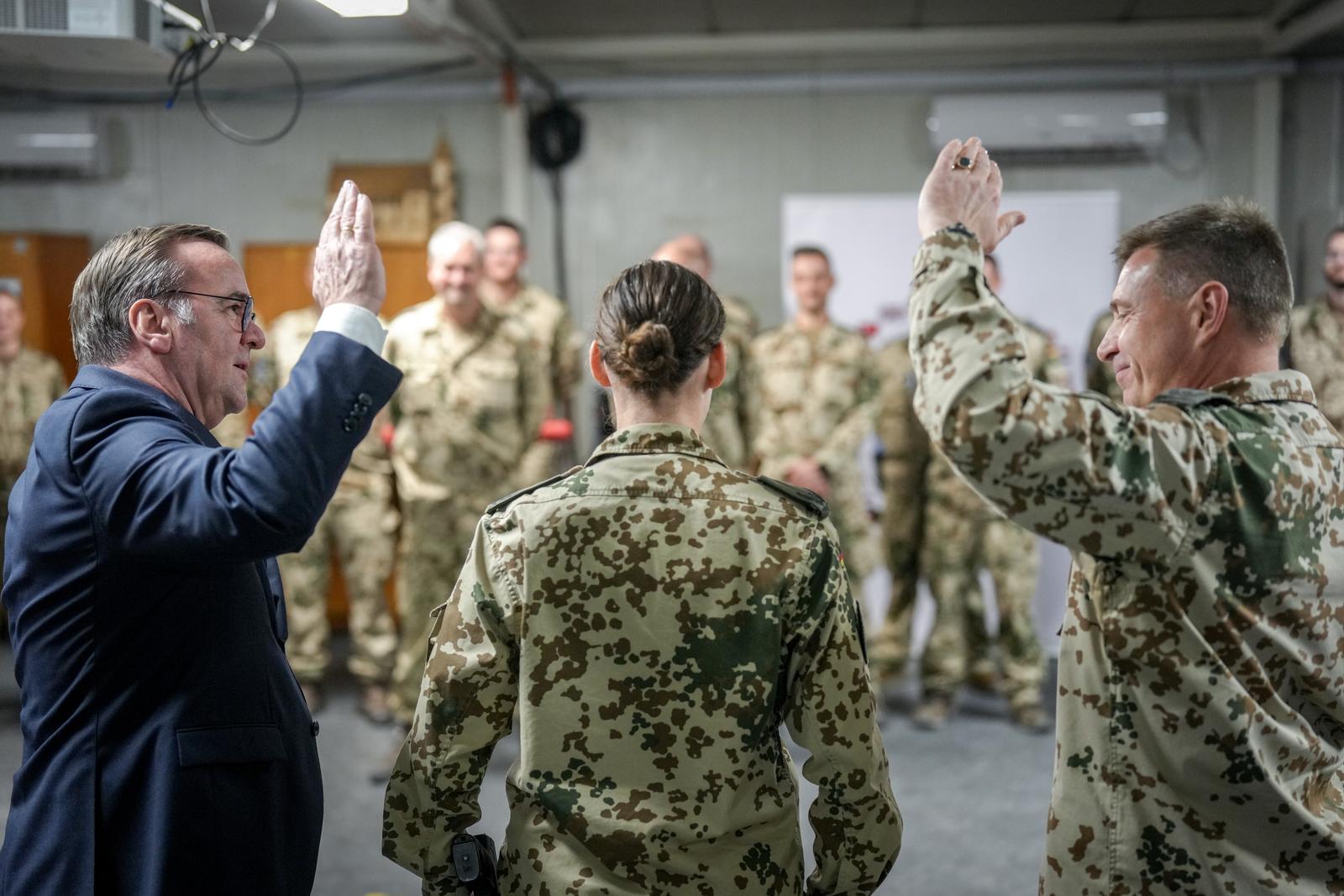 11 December 2024, Iran, Bagdad: CORRECTING COUNTRY AND CITY - Boris Pistorius (l, SPD), Federal Minister of Defense, promotes a female soldier to major together with Colonel Gero von Fritschen (r), leader of German forces NMI Baghdad. The SPD politician visits German soldiers in action and holds political talks on Germany's continued involvement against the backdrop of the upheaval in Syria. Photo: Kay Nietfeld/dpa Photo: Kay Nietfeld/DPA