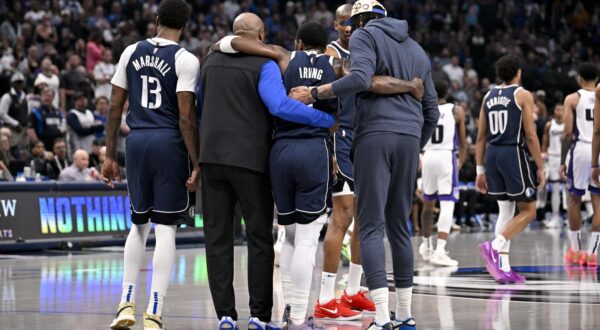 Mar 3, 2025; Dallas, Texas, USA; Dallas Mavericks guard Kyrie Irving (11) is helped off the court by forward Naji Marshall (13) and forward Anthony Davis (3) during the second quarter against the Sacramento Kings at the American Airlines Center. Mandatory Credit: Jerome Miron-Imagn Images Photo: Jerome Miron/REUTERS