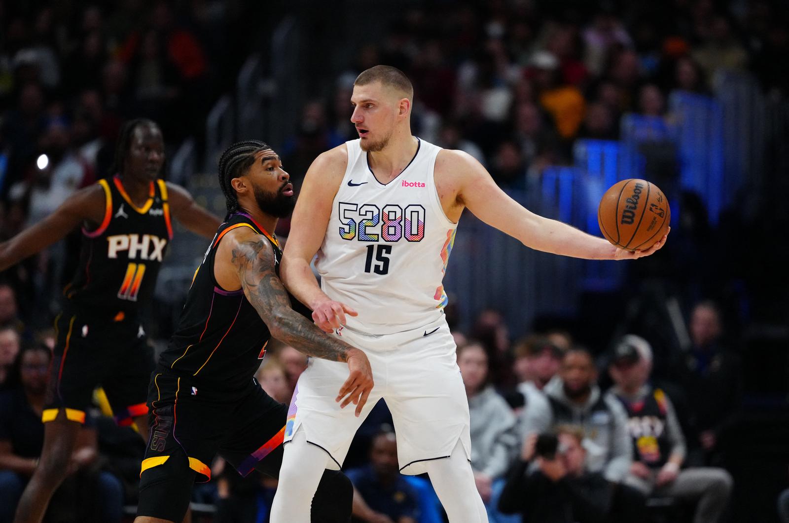 Mar 7, 2025; Denver, Colorado, USA;  Phoenix Suns center Nick Richards (2) defends on Denver Nuggets center Nikola Jokic (15) in the first quarter at Ball Arena. Mandatory Credit: Ron Chenoy-Imagn Images Photo: Ron Chenoy/REUTERS