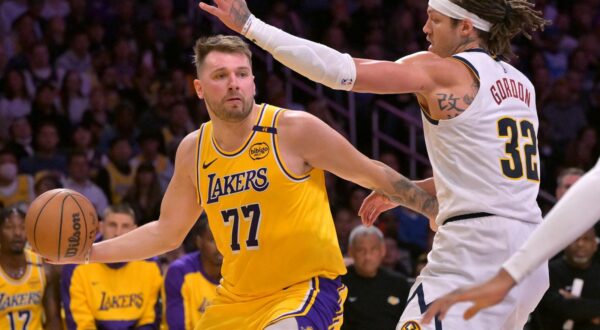 Mar 19, 2025; Los Angeles, California, USA;  Los Angeles Lakers guard Luka Doncic (77) is guarded by Denver Nuggets forward Aaron Gordon (32) in the first half at Crypto.com Arena. Mandatory Credit: Jayne Kamin-Oncea-Imagn Images Photo: Jayne Kamin-Oncea/REUTERS