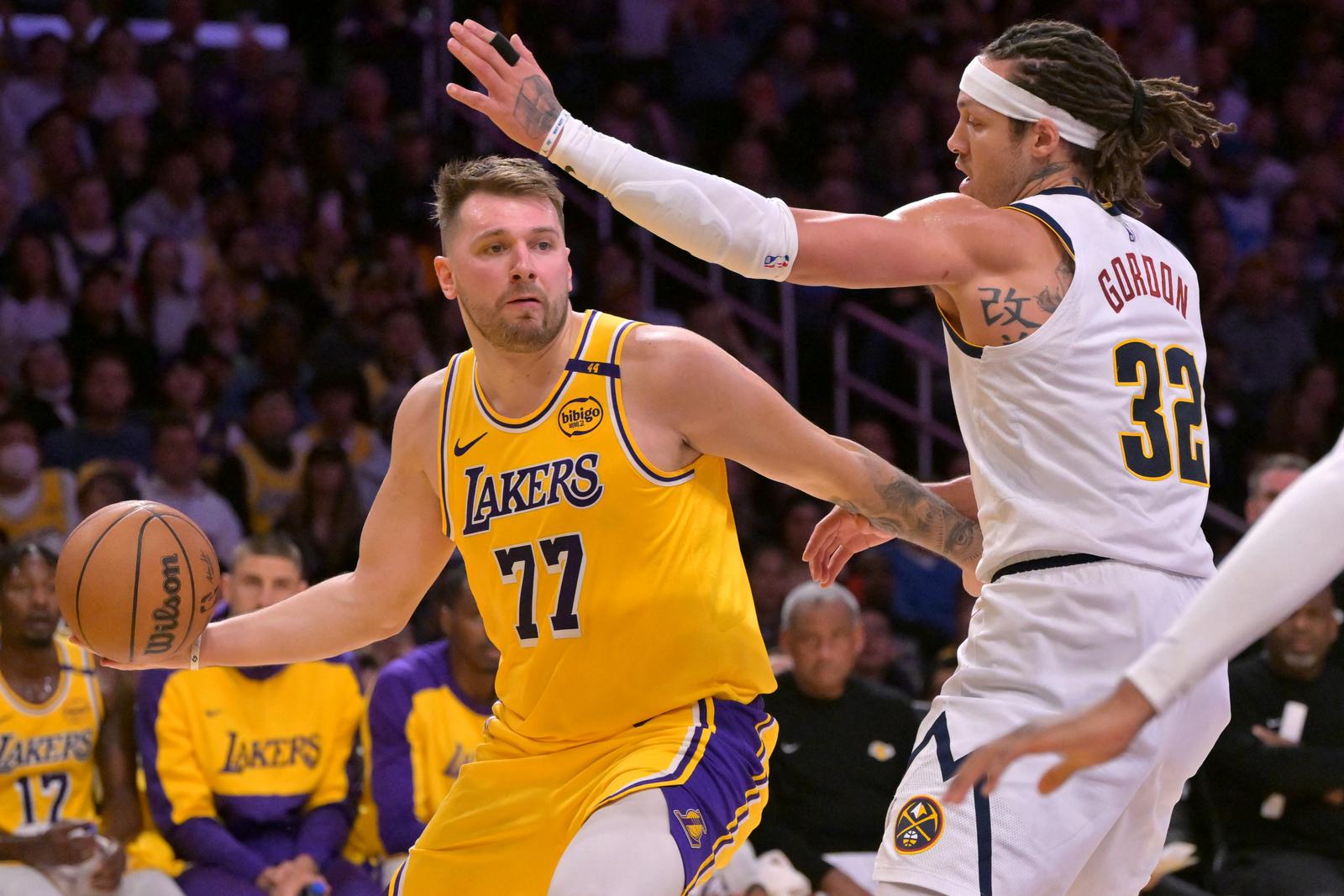 Mar 19, 2025; Los Angeles, California, USA;  Los Angeles Lakers guard Luka Doncic (77) is guarded by Denver Nuggets forward Aaron Gordon (32) in the first half at Crypto.com Arena. Mandatory Credit: Jayne Kamin-Oncea-Imagn Images Photo: Jayne Kamin-Oncea/REUTERS