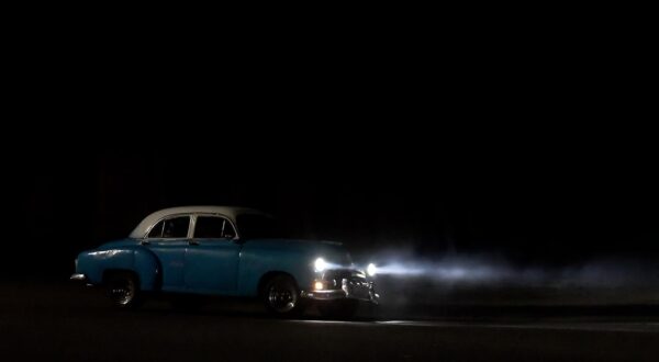 (250217) -- HAVANA, Feb. 17, 2025 (Xinhua) -- A vintage car drives along a dark avenue after a power outage in Havana, Cuba, on Feb. 15, 2025.   Cuba's Ministry of Labor and Social Security announced on Feb. 13 that given the current power situation, all non-essential educational and work activities were suspended on Feb. 14 and 15.   Due to U.S. sanctions, the country has long struggled to import fuel and repair its severely aging power generation equipment, leading to a tight nationwide electricity supply. (Photo by Joaquin Hernandez/Xinhua) Photo: JOAQUIN HERNANDEZ/XINHUA