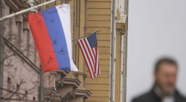 epa11958141 A man walks near Russian (front) and US flags hanging on the main building of the US Embassy in Moscow, Russia, 12 March 2025. The Kremlin expects the US to inform Russia about the results of the US-Ukrainian talks in Jeddah, and does not rule out a telephone conversation between Presidents Vladimir Putin and Donald Trump, said Dmitry Peskov, the press secretary of the head of the Russian state. As a result of the talks between the American and Ukrainian sides in Saudi Arabia, Kyiv agreed to a 30-day truce in the conflict in Ukraine.  EPA/SERGEI ILNITSKY