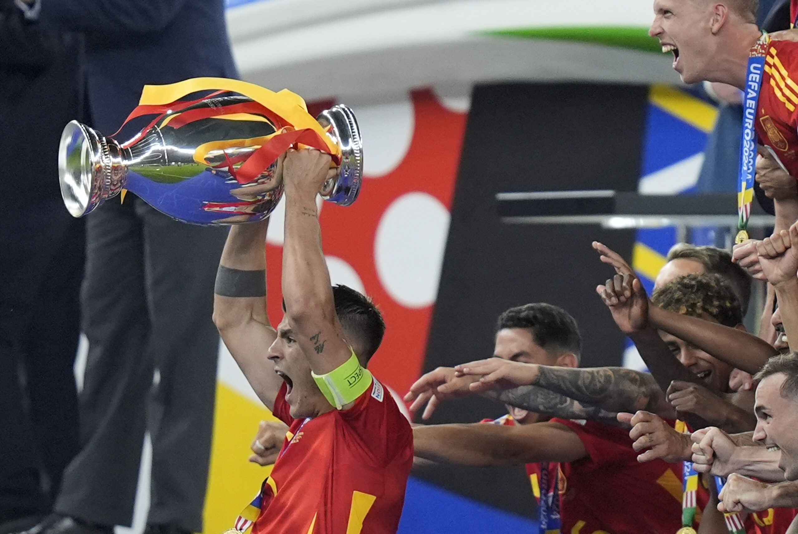 Spain's Alvaro Morata, left, lifts the trophy after Spain won the final match between Spain and England at the Euro 2024 soccer tournament in Berlin, Germany, Sunday, July 14, 2024. (AP Photo/Matthias Schrader)