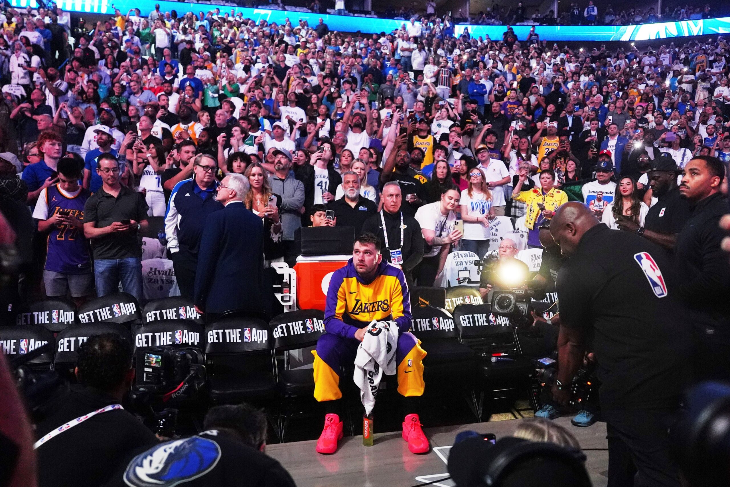 Los Angeles Lakers' Luka Doncic sits on the bench looking up at a video that was played in the arena as a tribute to the former Mavericks player before an NBA basketball game against the Dallas Mavericks in Dallas, Wednesday, April 9, 2025. (AP Photo/LM Otero) Lakers Mavericks Basketball