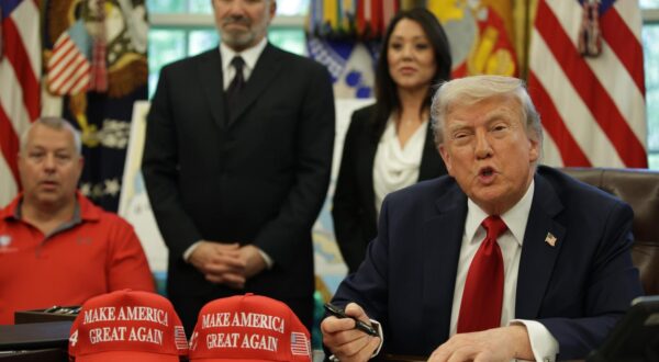United States President Donald Trump signs executive orders in the Oval Office of the White House on April 23, 2025 in Washington, D.C. In the background: US Secretary of Commerce Howard Lutnick (L) and Secretary of Labor Lori Chavez-DeRemer (R). The orders signed today focus on education. Credit: Samuel Corum / Pool via CNP *** Local Caption *** 60950409
