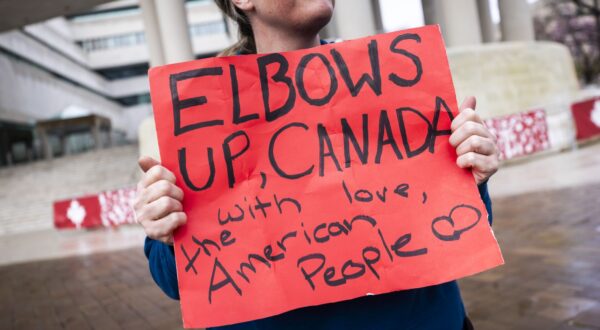 epa11986067 A supporter of Canadian solidarity stands outside the Canadian embassy to protest the Trump administration's calls to make Canada the 51st American state in Washington, DC, USA, 24 March 2025. Canadian Prime Minister Mark Carney warned on 23 March that US President Trump 'wants to break us so America can own us.'  EPA/JIM LO SCALZO