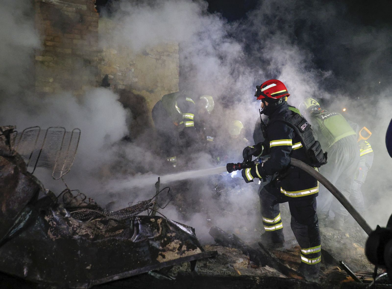 epa12008772 Ukrainian rescuers work at the site of a drone attack in Kharkiv, Ukraine, late 03 April 2025 (issued 04 April 2025), amid the ongoing Russian invasion. At least four people died and 35 other people were injured, including one child, according to the State Emergency Service.  EPA/SERGEY KOZLOV