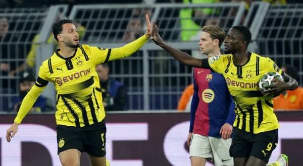epa12033757 Serhou Guirassy (R) of Dortmund celebrates with teammate Ramy Bensebaini after scoring the 1-0 goal during the UEFA Champions League quarter-finals, 2nd leg soccer match between Borussia Dortmund and FC Barcelona, in Dortmund, Germany, 15 April 2025.  EPA/FRIEDEMANN VOGEL