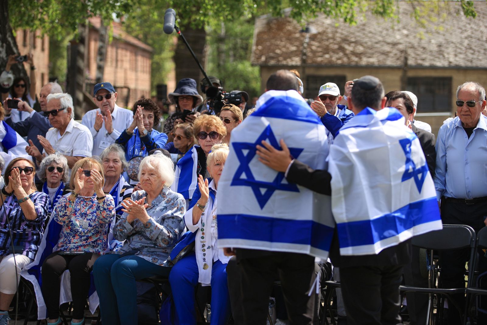 epa12050993 Holocaust survivors and participants before the 'March of the Living' at the former German Nazi death camp Auschwitz-Birkenau in Oswiecim, southern Poland, 24 April 2025. The annual 'March of the Living' to commemorate the Holocaust takes place at the site of the Auschwitz-Birkenau Nazi death camp. The March of the Living has been held since 1988 to commemorate Holocaust Remembrance Day.  EPA/JAREK PRASZKIEWICZ POLAND OUT