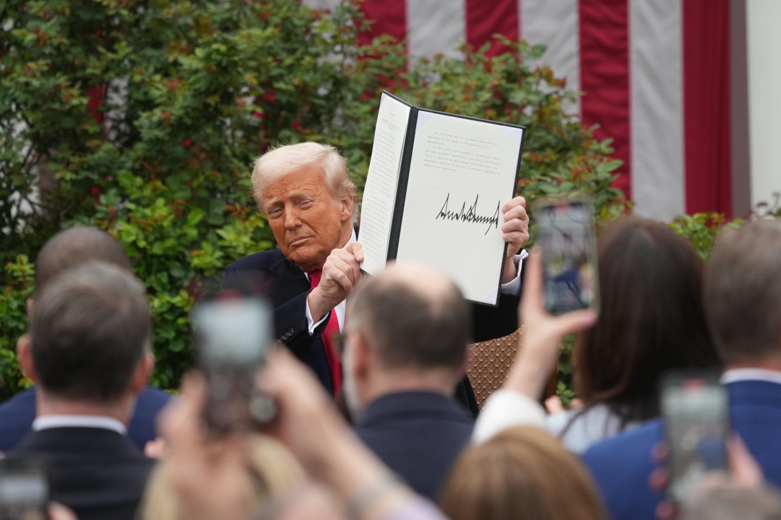 United States President Donald J Trump displays the signed Executive Order after concluding his remarks during a “Make America Wealthy Again” event in the Rose Garden of the White House in Washington, DC on Wednesday, April 2, 2025.  The President has called this day “Liberation Day” as he announces a set of “reciprocal tariffs” in response to alleged years of unfair trade practices by other nations.
Credit: Chris Kleponis / CNP/AdMedia Photo: CNP/AdMedia/NEWSCOM