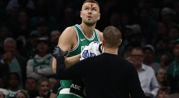 Apr 23, 2025; Boston, Massachusetts, USA; Boston Celtics center Kristaps Porzingis (8) is helped off the court after being cut by an elbow to the head against the Orlando Magic during the second half of game two of the first round of the 2024 NBA Playoffs at TD Garden. Mandatory Credit: Winslow Townson-Imagn Images Photo: Winslow Townson/REUTERS