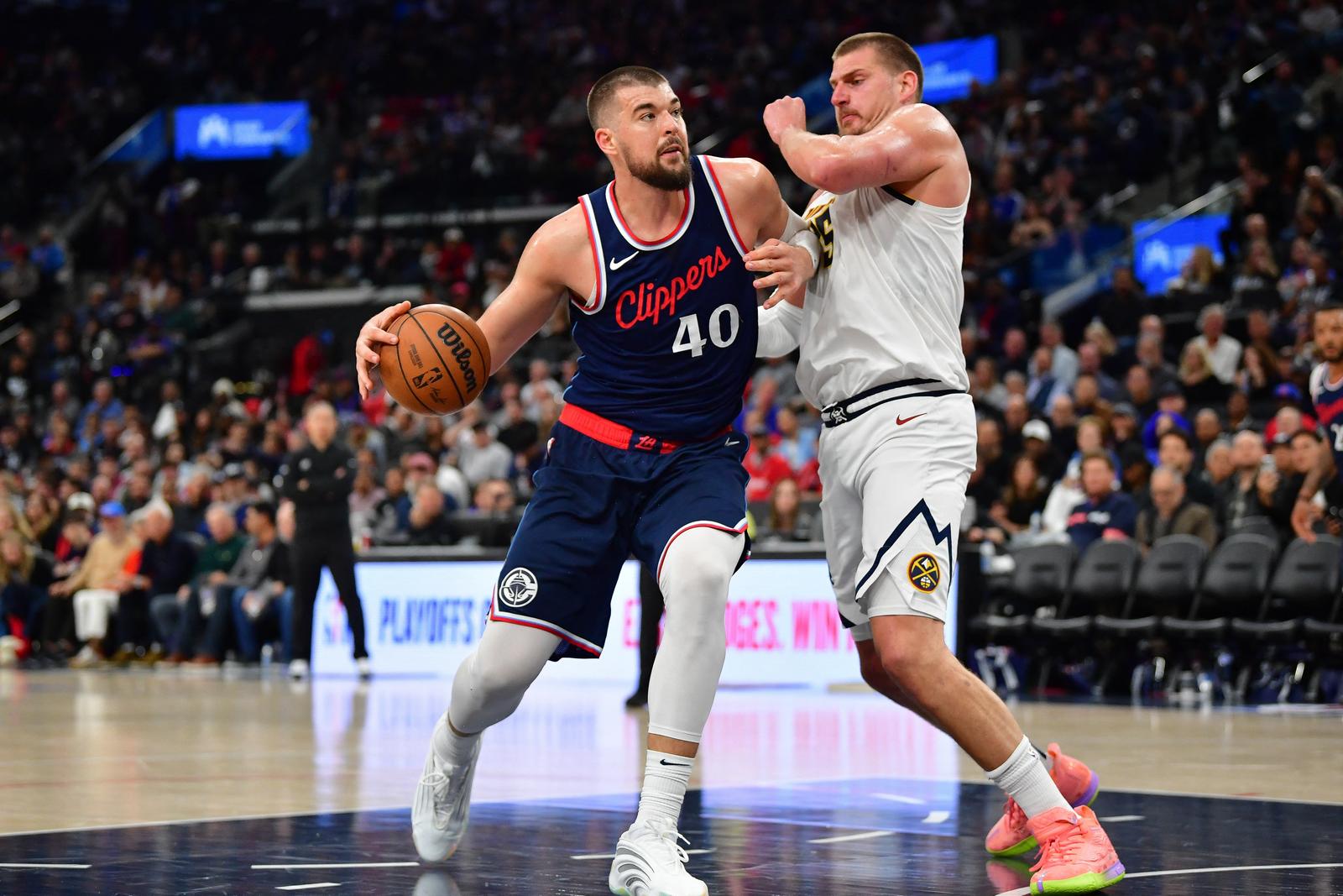 Apr 24, 2025; Inglewood, California, USA; Los Angeles Clippers center Ivica Zubac (40) moves to the basket against Denver Nuggets center Nikola Jokic (15) during the second half of game three in the first round for the 2024 NBA Playoffs at Intuit Dome. Mandatory Credit: Gary A. Vasquez-Imagn Images Photo: Gary A. Vasquez/REUTERS