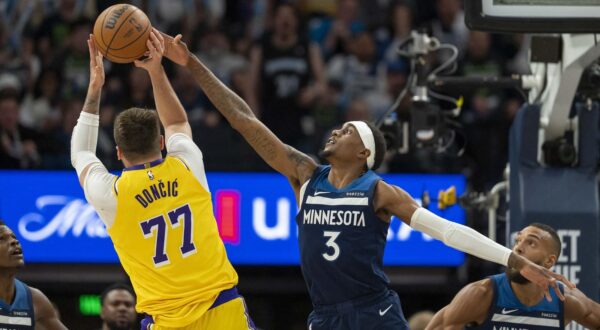 Apr 25, 2025; Minneapolis, Minnesota, USA; Los Angeles Lakers guard Luka Doncic (77) shoots the ball over Minnesota Timberwolves forward Jaden McDaniels (3) in the second half during game three of first round for the 2024 NBA Playoffs at Target Center. Mandatory Credit: Jesse Johnson-Imagn Images Photo: Jesse Johnson/REUTERS