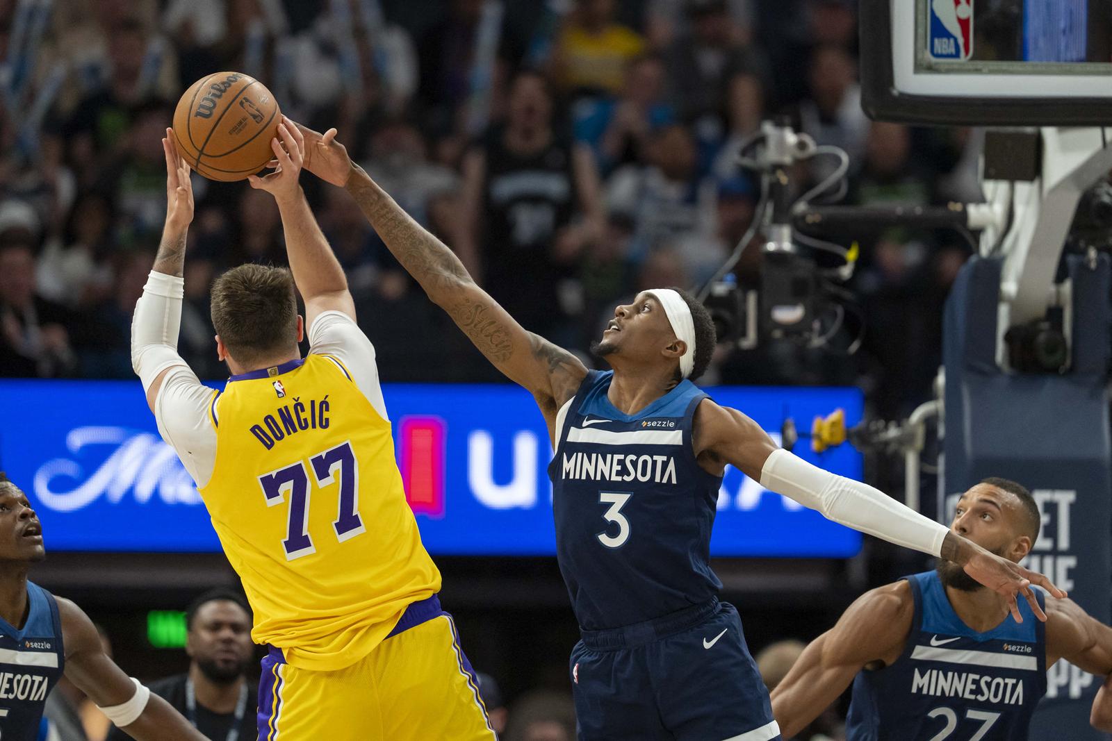 Apr 25, 2025; Minneapolis, Minnesota, USA; Los Angeles Lakers guard Luka Doncic (77) shoots the ball over Minnesota Timberwolves forward Jaden McDaniels (3) in the second half during game three of first round for the 2024 NBA Playoffs at Target Center. Mandatory Credit: Jesse Johnson-Imagn Images Photo: Jesse Johnson/REUTERS