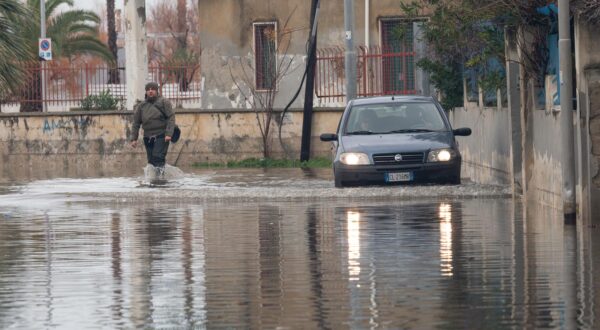 A man and a car try to cross a flooded road in Schiavonea, a seaside village flooded following heavy rains that hit all the coasts of Ionian Calabria. The coasts of Ionian Calabria, in southern Italy, were hit by a Mediterranean cyclone that brought devastation with strong winds and heavy rains, for some days in Calabria there has been a red alert from the civil protection for bad weather. This is also an effect of climate change. (Photo by Alfonso Di Vincenzo / ipa-agency.net/IPA/Sipa USA) Photo: IPA/SIPA USA