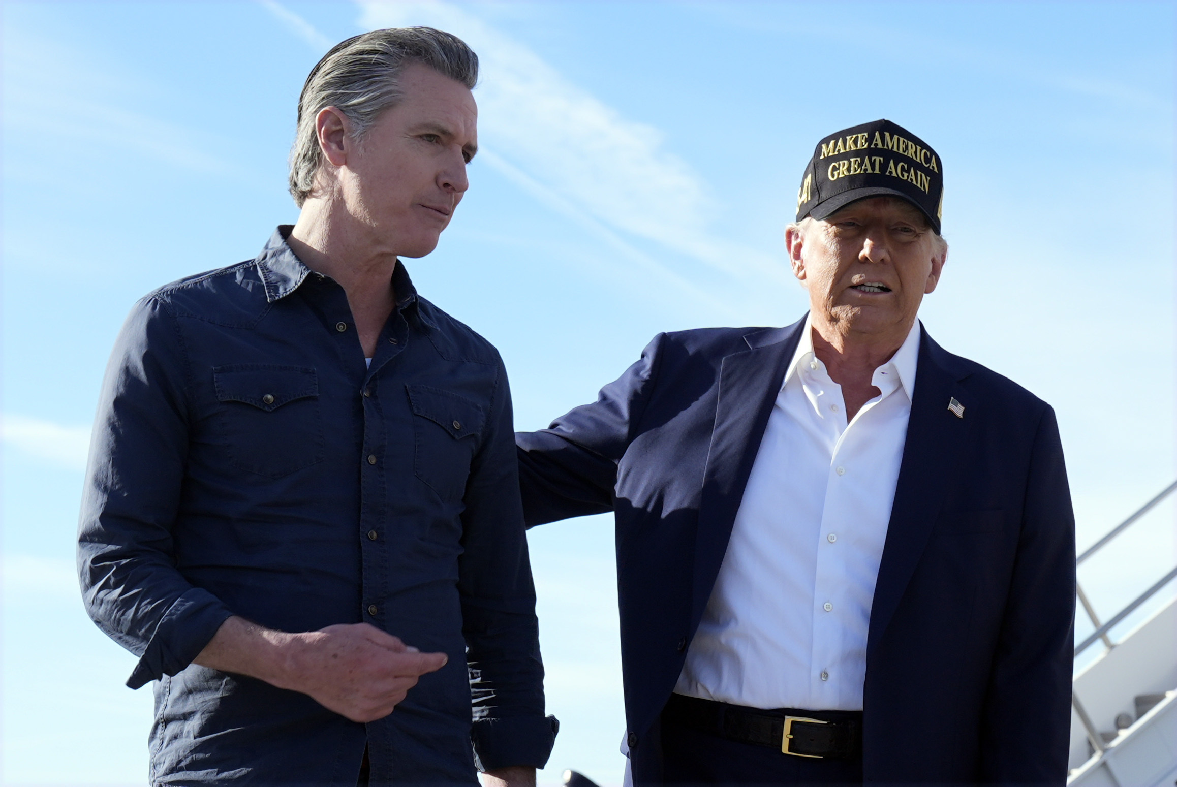 President Donald Trump and California Gov. Gavin Newsom walk to speak to reporters after arriving on Air Force One at Los Angeles International Airport in Los Angeles, Friday, Jan. 24, 2025. (AP Photo/Mark Schiefelbein)
