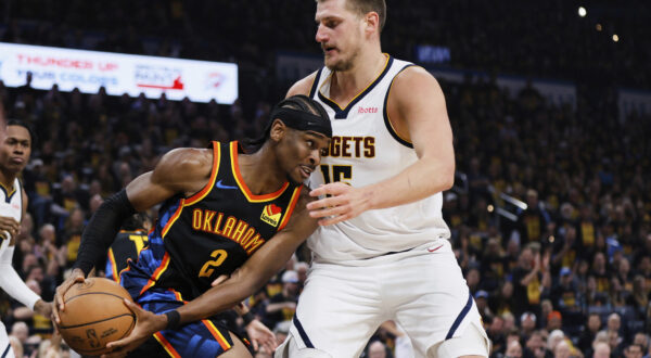 Oklahoma City Thunder guard Shai Gilgeous-Alexander (2) works against Denver Nuggets center Nikola Jokic (15) in the first half of Game 1 of an NBA basketball second-round playoff series Monday, May 5, 2025, in Oklahoma City. (AP Photo/Nate Billings)
