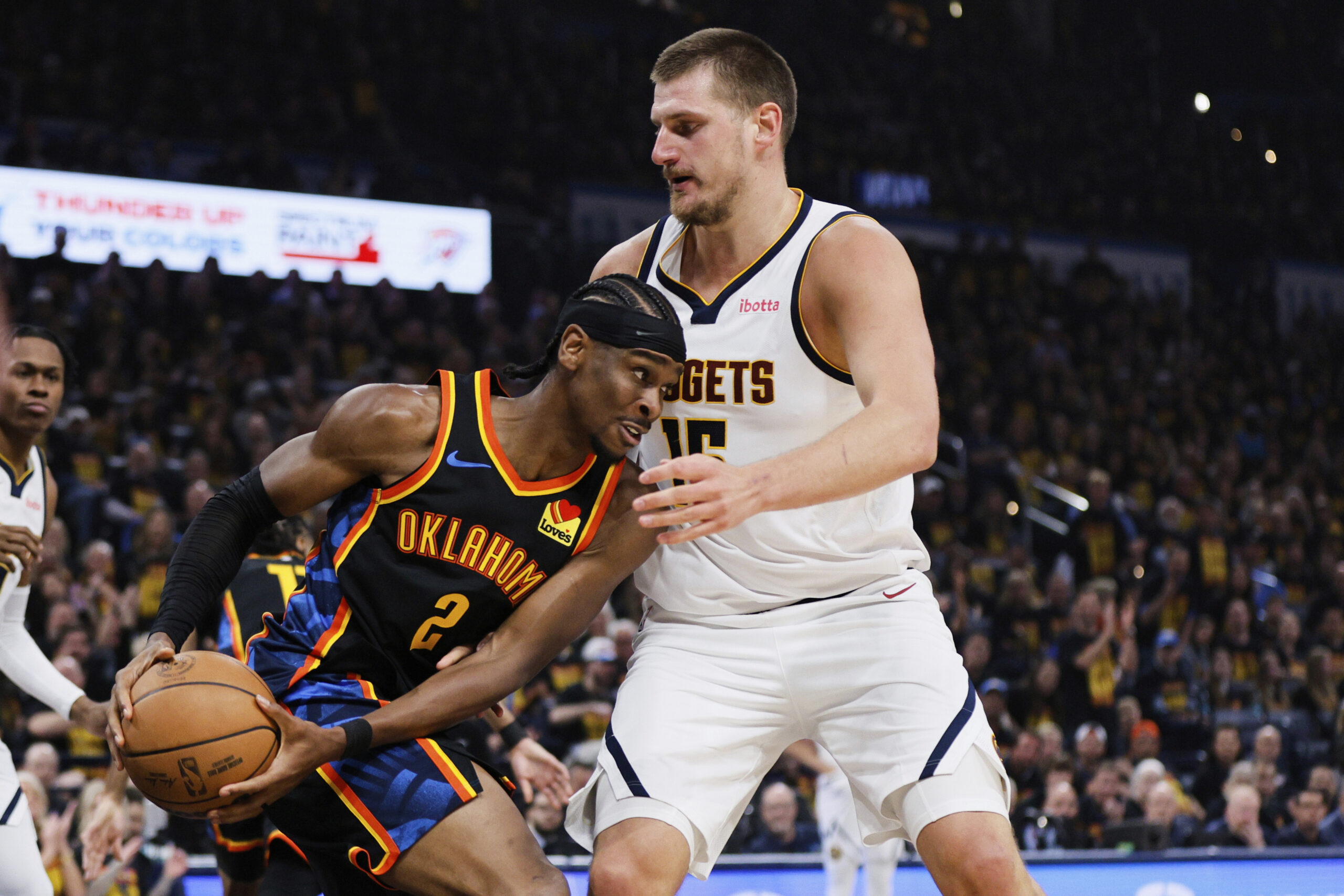 Oklahoma City Thunder guard Shai Gilgeous-Alexander (2) works against Denver Nuggets center Nikola Jokic (15) in the first half of Game 1 of an NBA basketball second-round playoff series Monday, May 5, 2025, in Oklahoma City. (AP Photo/Nate Billings)