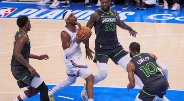 Oklahoma City Thunder guard Shai Gilgeous-Alexander, center, drives to the basket against Minnesota Timberwolves guard Anthony Edwards, left, forward Julius Randle (30) and guard Mike Conley (10) during the first half of Game 1 of an NBA basketball Western Conference Finals playoff series Tuesday, May 20, 2025, in Oklahoma City. (AP Photo/Nate Billings) Timberwolves Thunder Basketball