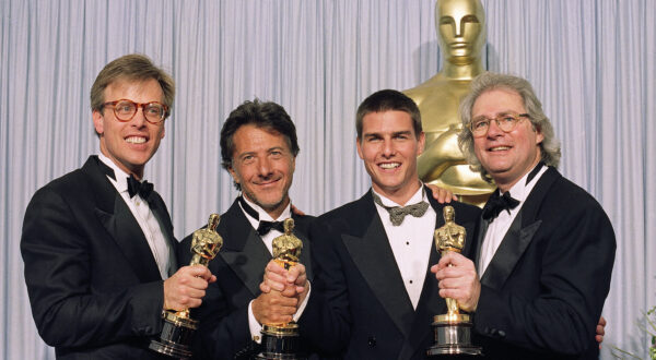 The principals of this years' best film, from left, Mark Johnson, Dustin Hoffman, Tom Cruise and Barry Levinson are all smiles as they display their "Oscars"  in Los Angeles, March 29, 1989 after "Rain Man" was named best film. This was the 61st Annual Academy Awards.   (AP Photo)