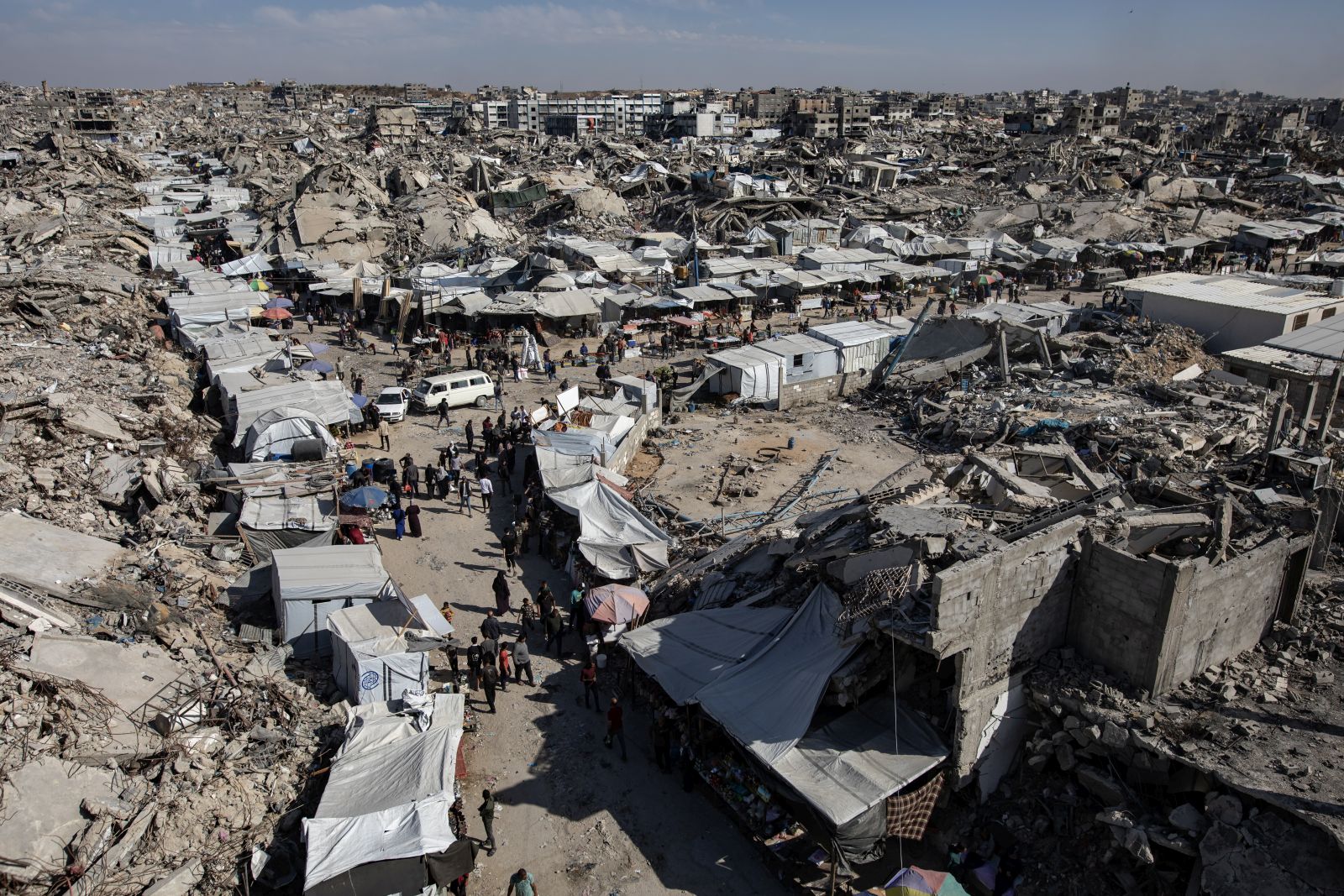 epa12058926 Displaced Palestinians gather at a market near the rubble of destroyed buildings in Jabalia, northern Gaza Strip, 27 April 2025. The UN World Food Programme (WFP) announced on 25 April it has depleted all food stocks for families in Gaza due to weeks of closed border crossings. Over a million Gazans face 'high levels' of acute food insecurity, with acute malnutrition several times higher than pre-war levels, the UN Palestinian refugee agency UNRWA warned.  EPA/HAITHAM IMAD