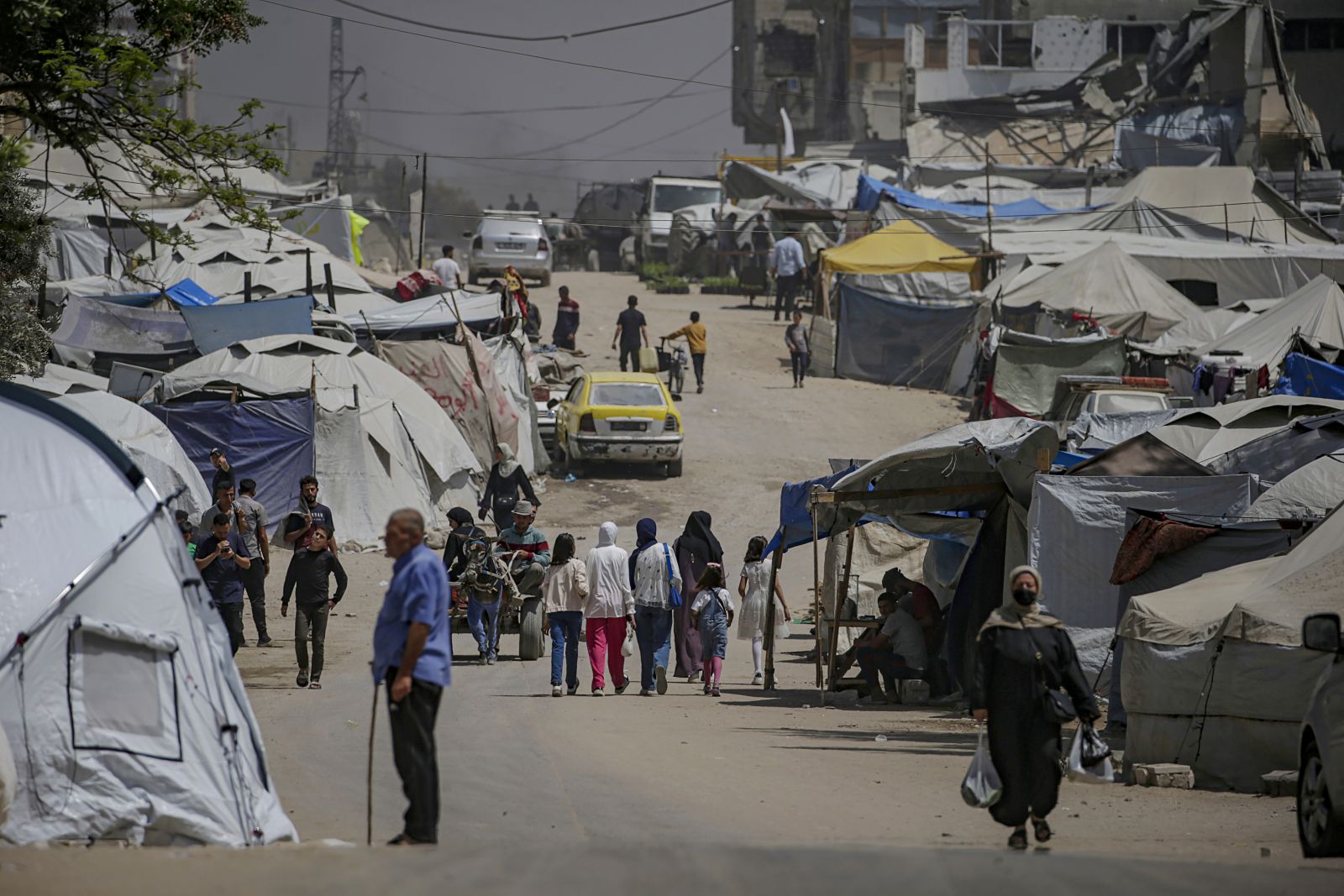epa12106339 Internally displaced Palestinians move between tents along Al Jalaa road in the central of Gaza City on, 16 May 2025. More than 51,000 Palestinians have been  More than 51,000 Palestinians have been killed in the Gaza Strip, according to the Palestinian Ministry of Health, since Israel launched a military campaign in the strip in response to a cross-border attack led by the Palestinian militant group Hamas on 07 October 2023, in which about 1,200 Israelis were killed and more than 250 taken hostage.  EPA/MOHAMMED SABER