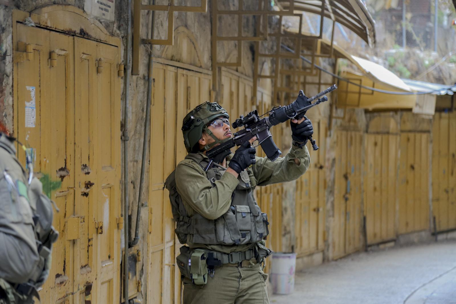 An Israeli soldier aims his weapon in the Old City area of Hebron, West Bank, on November 16, 2024. Israeli soldiers conduct a raid in the Old City of Hebron to secure the area for Israelis entering a historical site. Photo by Mosab Shawer/Middle East Images/ABACAPRESS.COM Photo: Middle East Images/ABACA/ABACA