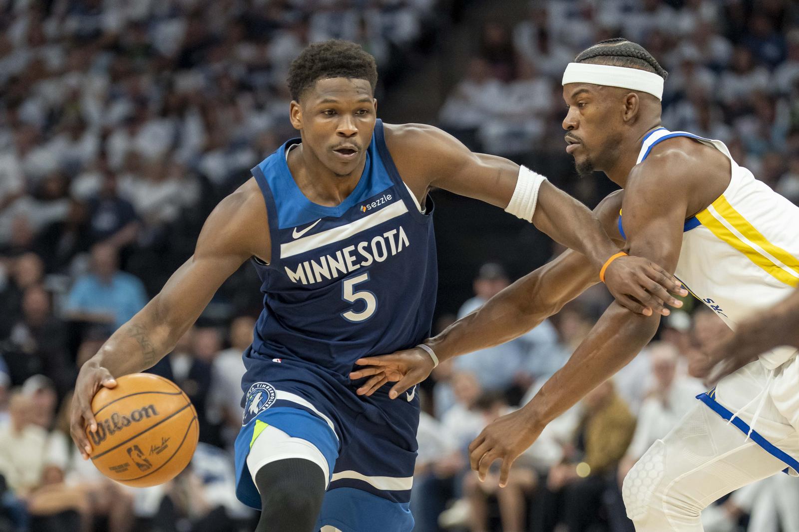 May 8, 2025; Minneapolis, Minnesota, USA; Minnesota Timberwolves guard Anthony Edwards (5) dribbles the ball past Golden State Warriors forward Jimmy Butler III (10) in the first half during game two of the second round for the 2025 NBA Playoffs at Target Center. Mandatory Credit: Jesse Johnson-Imagn Images/Sipa USA Photo: Imagn Images/SIPA USA