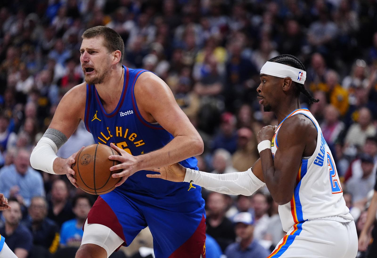 May 9, 2025; Denver, Colorado, USA; Oklahoma City Thunder guard Shai Gilgeous-Alexander (2) defends on Denver Nuggets center Nikola Jokic (15) in the second half during game three of the second round for the 2025 NBA Playoffs at Ball Arena. Mandatory Credit: Ron Chenoy-Imagn Images/Sipa USA Photo: Imagn Images/SIPA USA