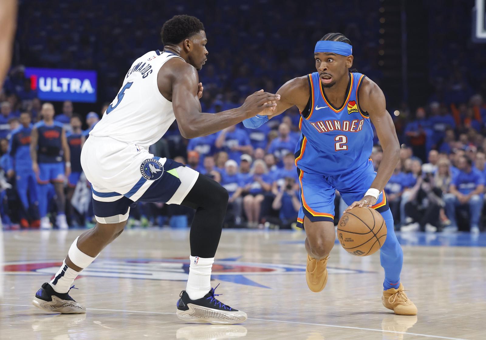 May 22, 2025; Oklahoma City, Oklahoma, USA; Oklahoma City Thunder guard Shai Gilgeous-Alexander (2) drives against Minnesota Timberwolves guard Anthony Edwards (5) in the first quarter during game two of the western conference finals for the 2025 NBA Playoffs at Paycom Center. Mandatory Credit: Alonzo Adams-Imagn Images/Sipa USA Photo: Imagn Images/SIPA USA
