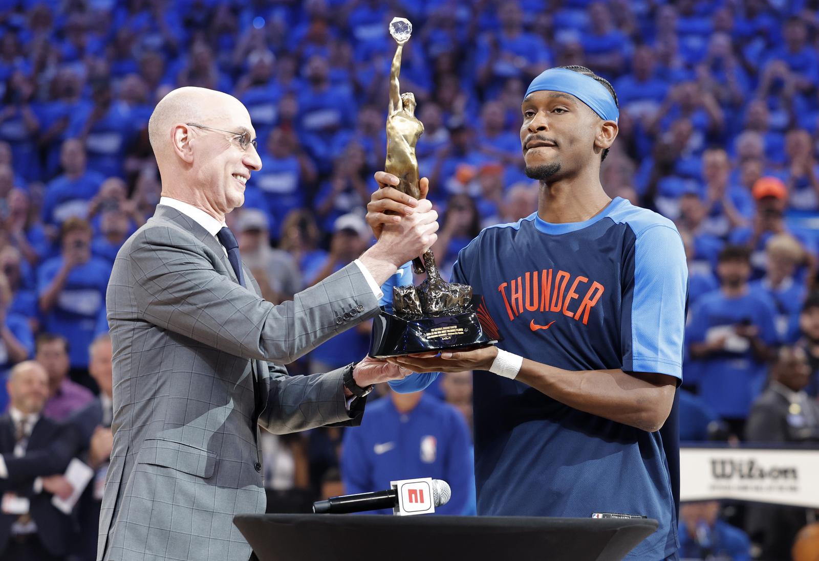 May 22, 2025; Oklahoma City, Oklahoma, USA; NBA commissioner is Adam Silver presents Oklahoma City Thunder guard Shai Gilgeous-Alexander (2) with the Michael Jordan Trophy for winning the most valuable player award for the 2024-25 season before game two of the western conference finals for the 2025 NBA Playoffs at Paycom Center. Mandatory Credit: Alonzo Adams-Imagn Images/Sipa USA Photo: Imagn Images/SIPA USA