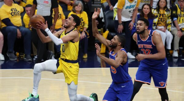 May 27, 2025; Indianapolis, Indiana, USA; Indiana Pacers guard Tyrese Haliburton (0) drives to the hoop past New York Knicks forward Mikal Bridges (25) during the fourth quarter of game four of the eastern conference finals for the 2025 NBA Playoffs at Gainbridge Fieldhouse. Mandatory Credit: Trevor Ruszkowski-Imagn Images/Sipa USA Photo: Imagn Images/SIPA USA